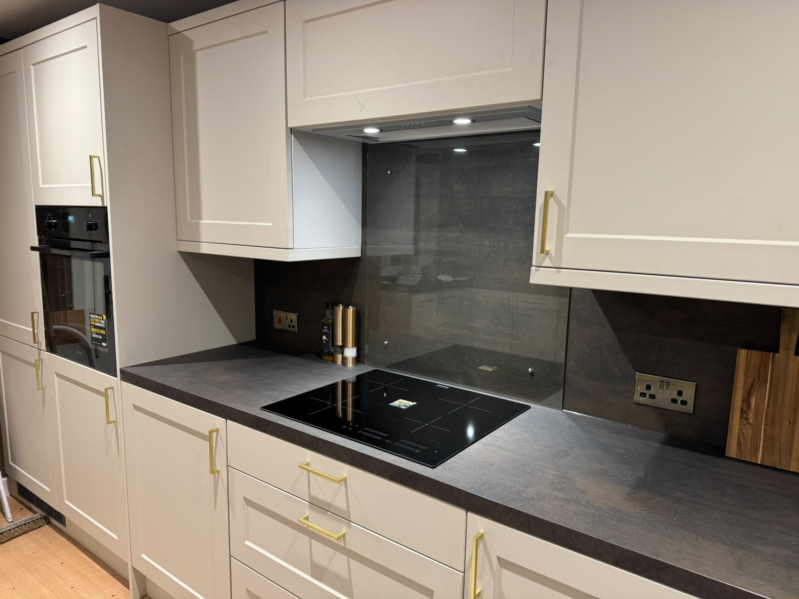 Finished kitchen with induction hob and integrated oven wired by Electrust